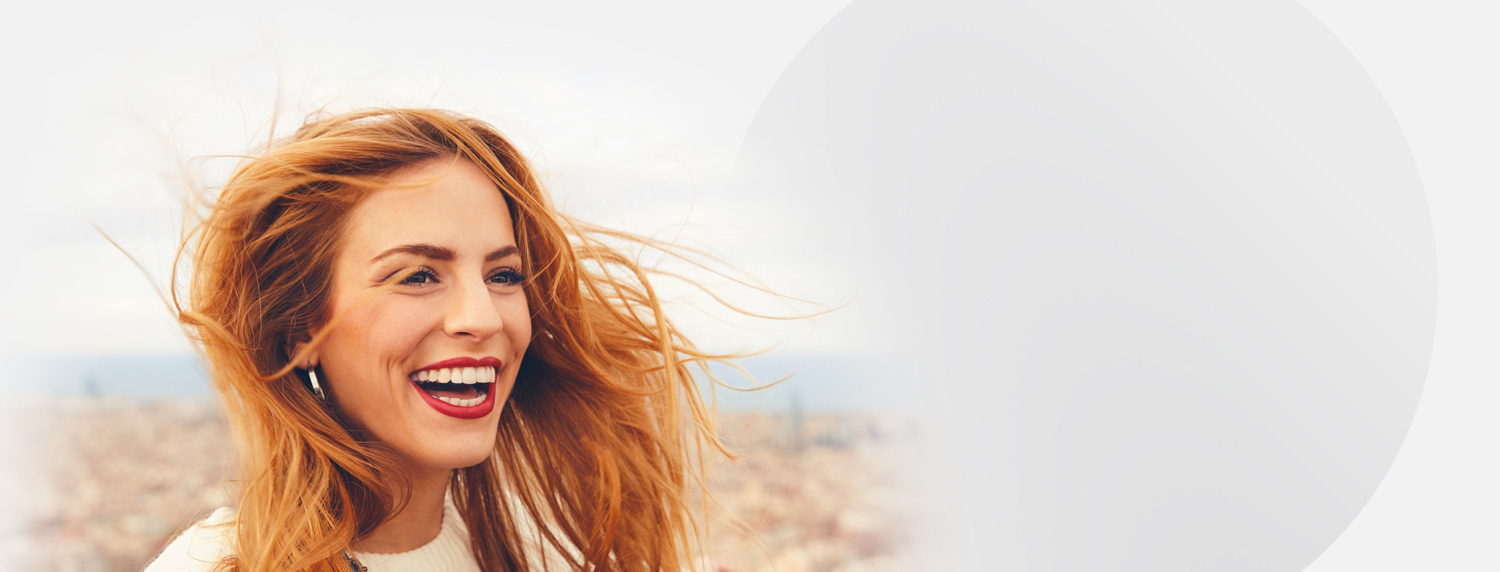 Smiling woman with red flowing hair